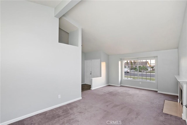 unfurnished living room with vaulted ceiling with beams and carpet floors