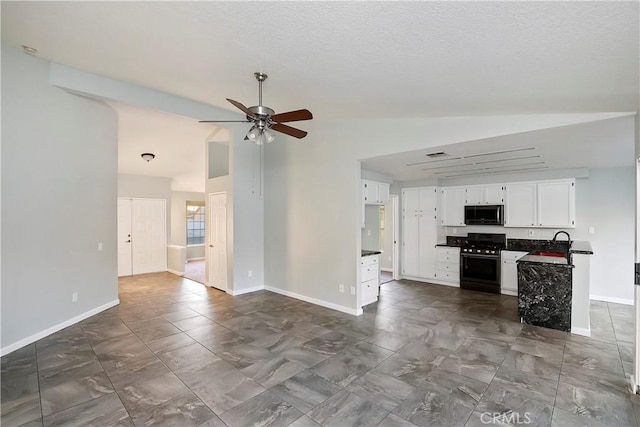 kitchen with ceiling fan, sink, lofted ceiling, white cabinets, and black appliances