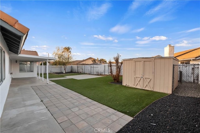 view of yard with a shed and a patio area