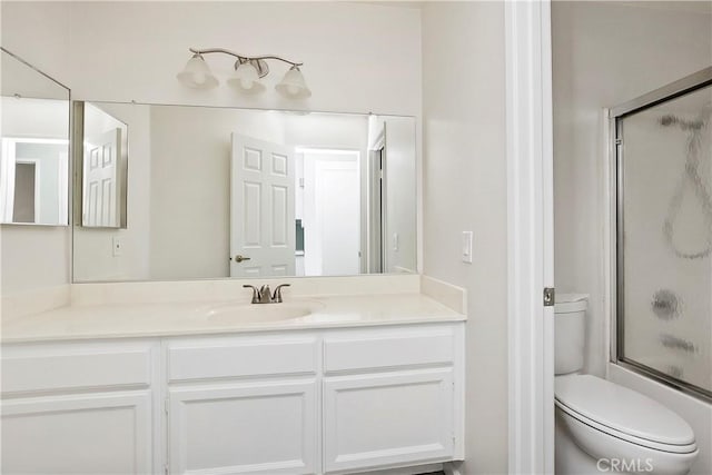 full bathroom with toilet, vanity, and combined bath / shower with glass door