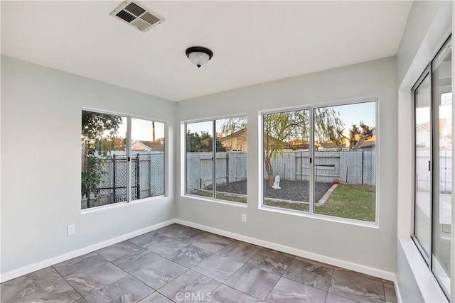 unfurnished sunroom with plenty of natural light