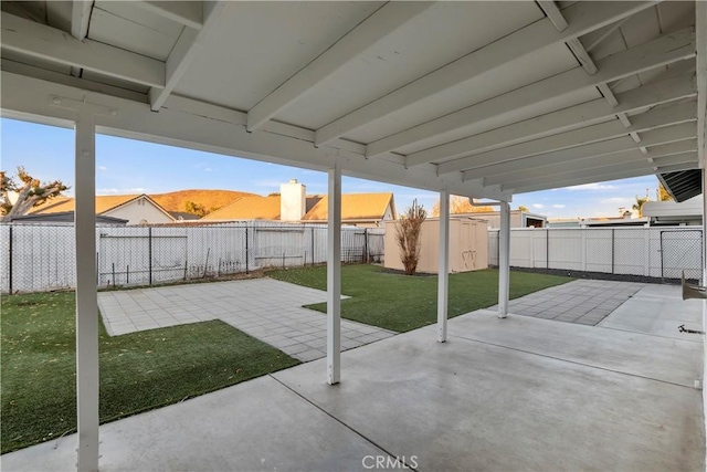 view of patio / terrace with a mountain view and a storage shed