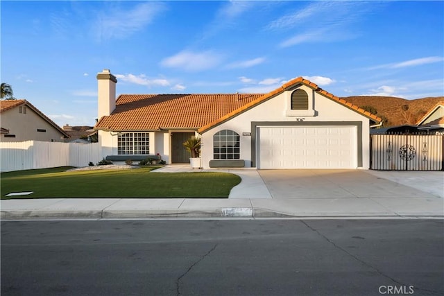 mediterranean / spanish-style house featuring a garage and a front yard