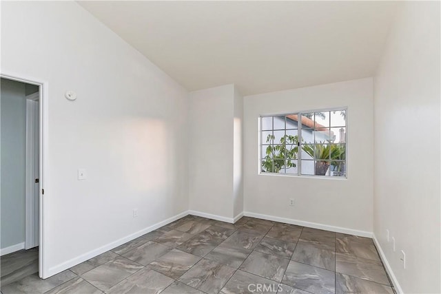 spare room with vaulted ceiling