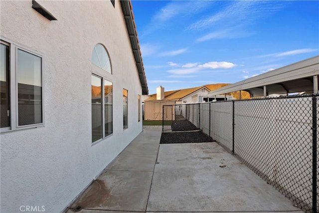 view of property exterior with a patio area