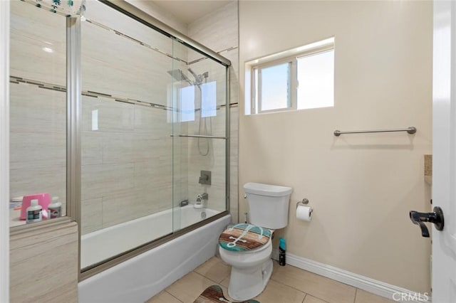 bathroom with toilet, enclosed tub / shower combo, and tile patterned floors