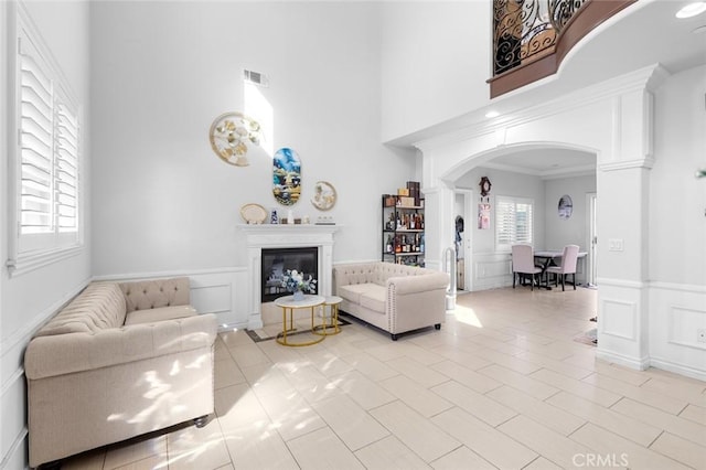 living room featuring a high ceiling and light tile patterned floors