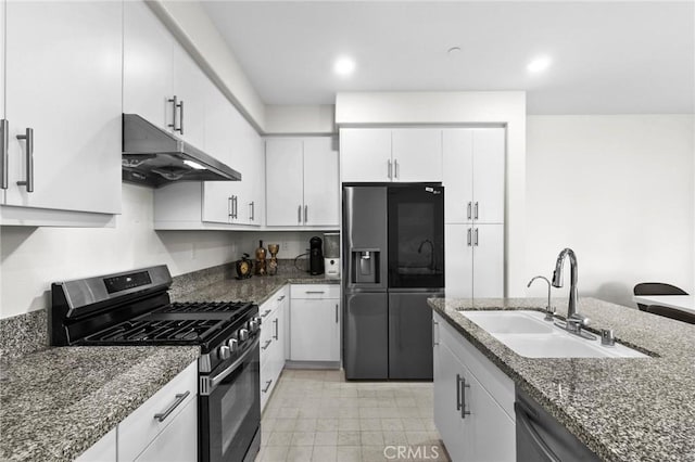 kitchen with white cabinetry, sink, dark stone counters, and appliances with stainless steel finishes