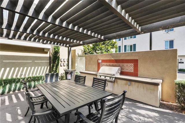 view of patio featuring a pergola, area for grilling, and exterior kitchen