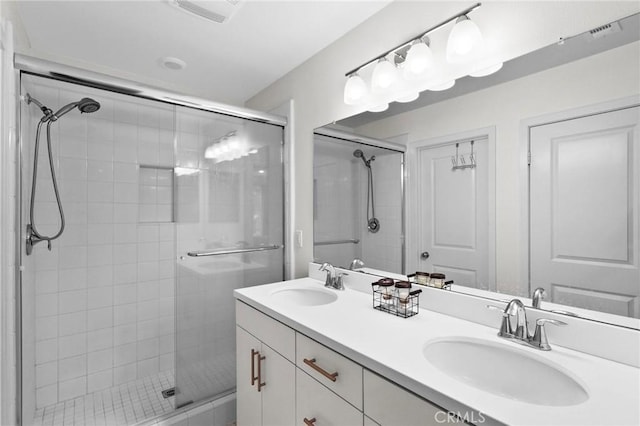 bathroom with a shower with door and vanity