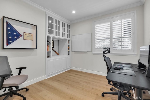 home office featuring light wood-type flooring and crown molding