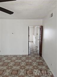 unfurnished room with ceiling fan