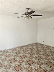 empty room featuring ceiling fan and a textured ceiling