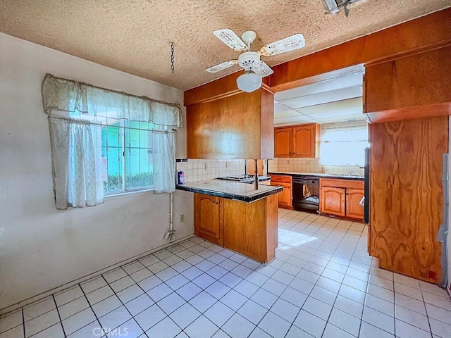 kitchen featuring a wealth of natural light, kitchen peninsula, black dishwasher, and a textured ceiling