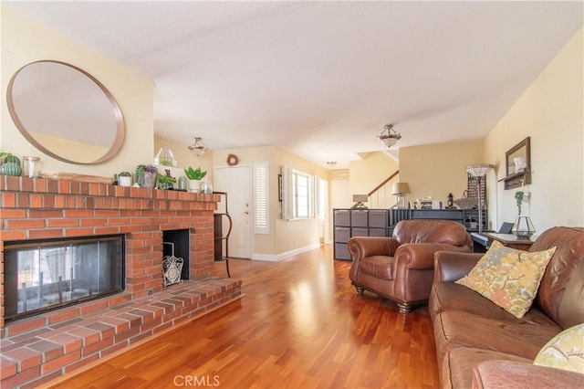 living room with hardwood / wood-style flooring and a fireplace