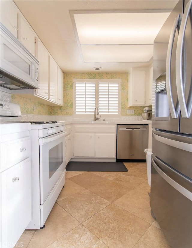 kitchen featuring white cabinetry, appliances with stainless steel finishes, and sink