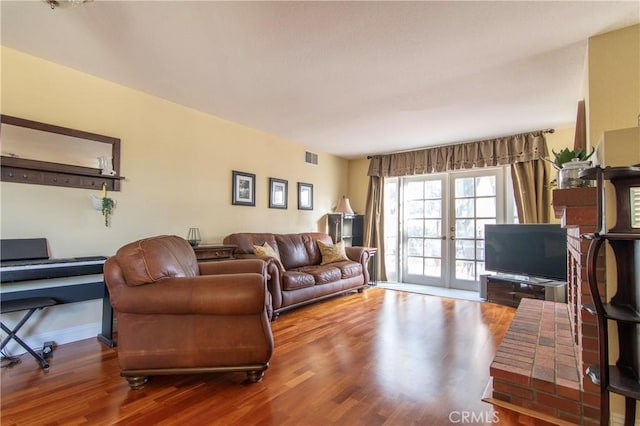 living room featuring french doors and wood-type flooring