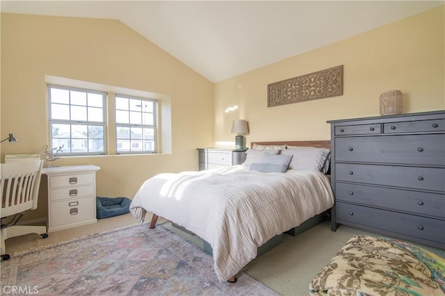 carpeted bedroom featuring lofted ceiling