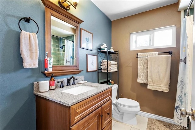 bathroom featuring tile patterned flooring, vanity, and toilet