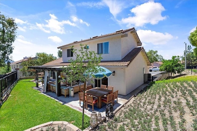 back of property featuring a yard and a patio