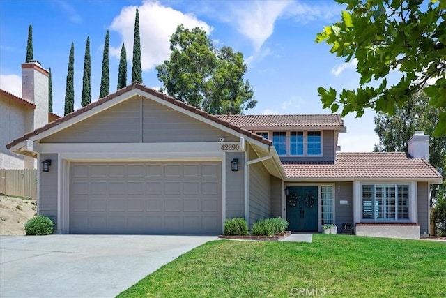 view of front of home featuring a garage and a front yard