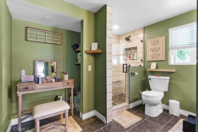 bathroom with toilet, tile patterned floors, and walk in shower