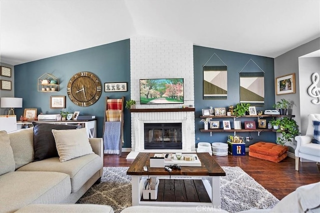 living room featuring a fireplace, wood-type flooring, and lofted ceiling