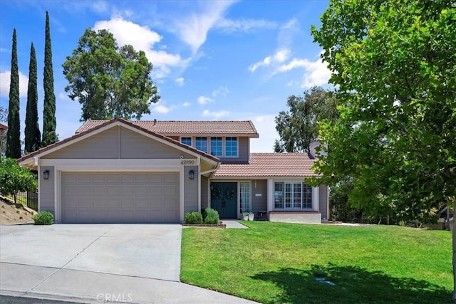 front of property featuring a garage and a front lawn