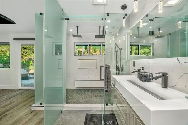 bathroom with vanity, hardwood / wood-style flooring, and a shower with door