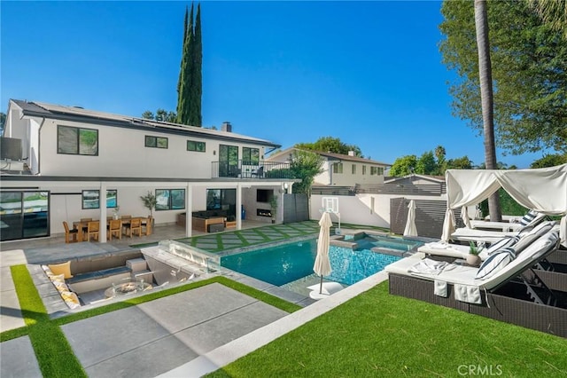 view of swimming pool with an outdoor hangout area, a patio area, a yard, and an in ground hot tub