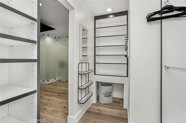 spacious closet featuring light hardwood / wood-style floors