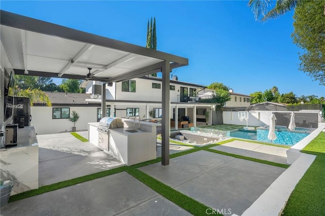 view of patio featuring ceiling fan, a balcony, an outdoor kitchen, and area for grilling