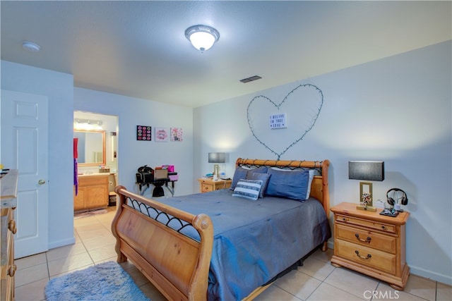 bedroom featuring light tile patterned floors and ensuite bath