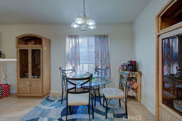 tiled dining space with a notable chandelier