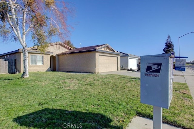 view of front of property with a garage and a front lawn