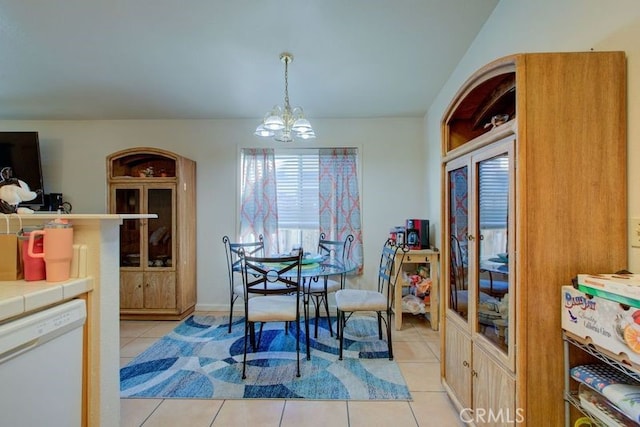 tiled dining space featuring a notable chandelier