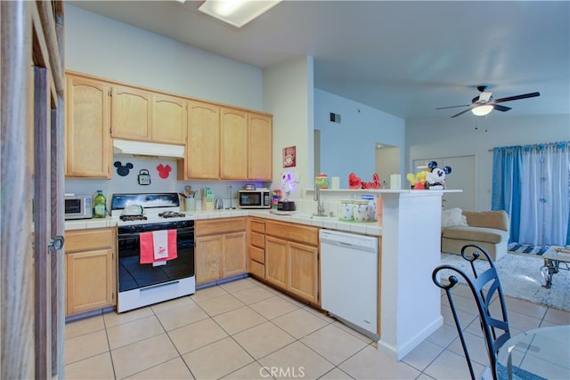 kitchen featuring light brown cabinetry, white appliances, ceiling fan, sink, and light tile patterned flooring