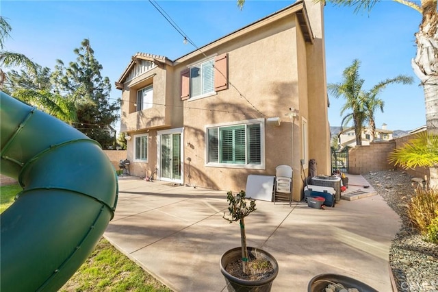 back of house with a patio