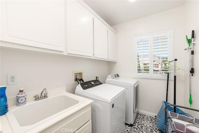 laundry area featuring cabinets, light tile patterned floors, washing machine and dryer, and sink