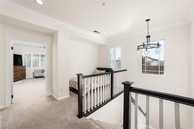 hall with plenty of natural light, crown molding, and light carpet