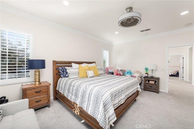 bedroom featuring crown molding and light colored carpet