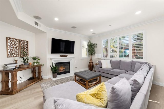 living room with light hardwood / wood-style floors and ornamental molding