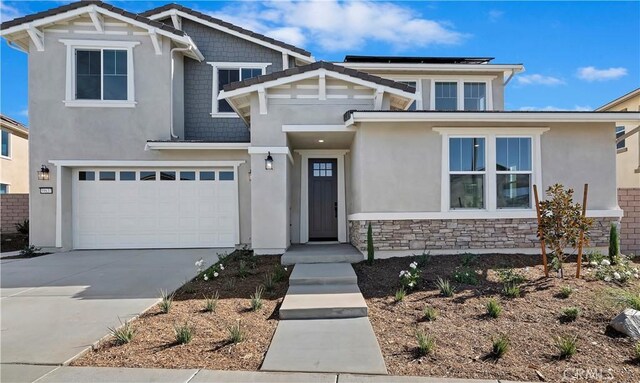 view of front of property featuring solar panels and a garage