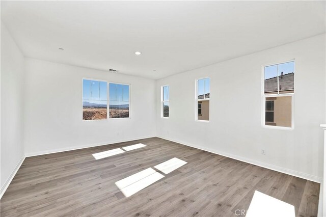 unfurnished room with wood-type flooring