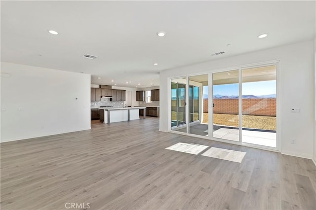 unfurnished living room featuring light hardwood / wood-style flooring