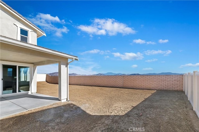 view of yard featuring a mountain view and a patio area