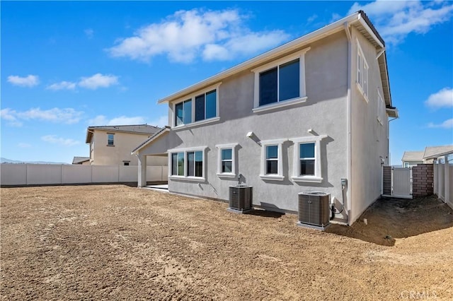 back of house with central AC unit