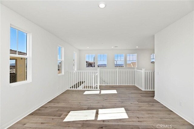 empty room with hardwood / wood-style flooring