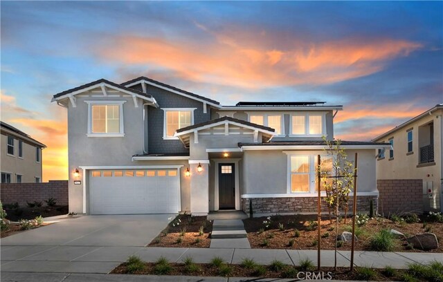 view of front of home featuring solar panels and a garage