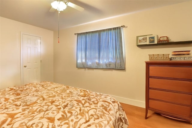 bedroom with hardwood / wood-style flooring and ceiling fan